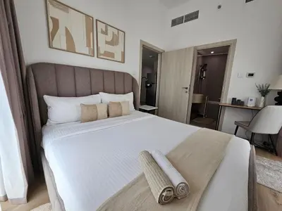 a bedroom with a large bed with two towels on it at Marina Water Residence in Dubai