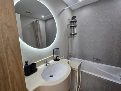 a bathroom with a sink and a mirror at Marina Water Residence in Dubai