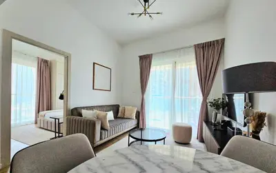 a living room with a couch and a table at Marina Water Residence in Dubai