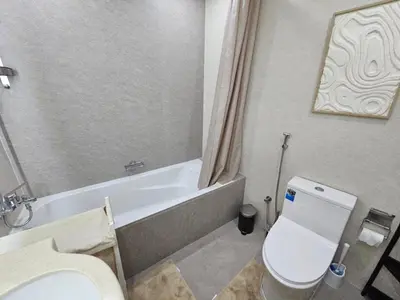 a bathroom with a toilet and a tub and a sink at Marina Water Residence in Dubai