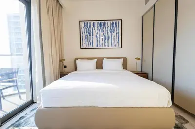 a bedroom with a white bed and a large window at Marina Vista - Elegant 1BR- 2606 in Dubai