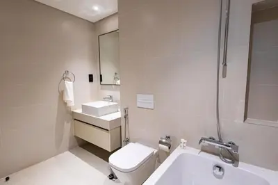 a bathroom with a toilet and a sink and a shower at Marina Vista - Elegant 1BR- 2606 in Dubai