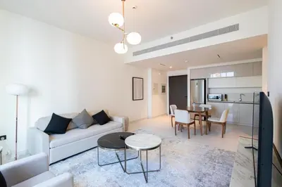 a living room with a couch and a table at Marina Vista - Elegant 1BR- 2606 in Dubai