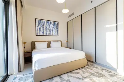 a bedroom with a white bed and a large window at Marina Vista - Elegant 1BR- 2606 in Dubai