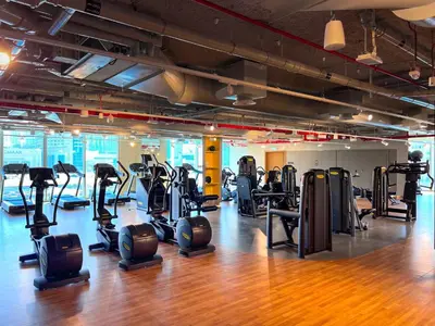 a gym with many treadmills and elliptical machines at Downtown views II in Dubai