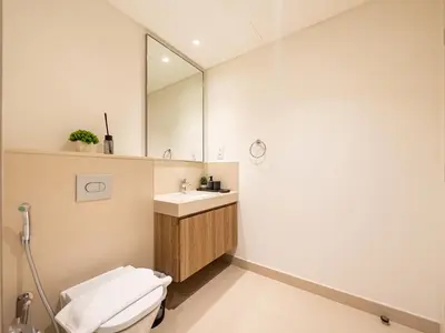 a bathroom with a toilet and a sink and a mirror at Downtown views II in Dubai