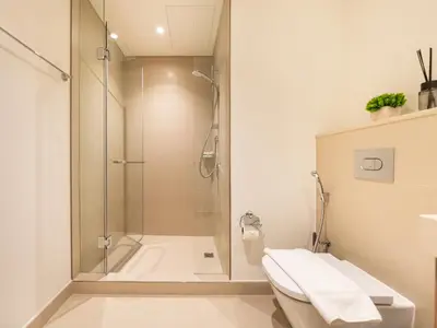 a bathroom with a shower and a toilet at Downtown views II in Dubai