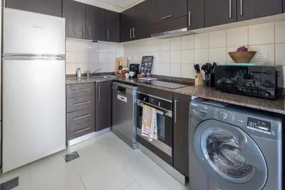 a kitchen with a washing machine and a washer at Frank Porter - Bay Central in Dubai
