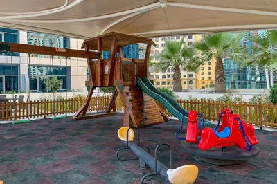 a playground with a slide in a building at Frank Porter - Bay Central in Dubai