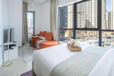 a hotel room with a bed and a large window at Frank Porter - Bay Central in Dubai