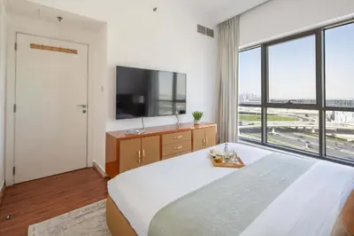 a bedroom with two beds and a large window at Frank Porter - RBC Tower in Dubai