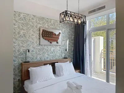 a bedroom with two white beds and a window at 3 Bed - Aquilegia, Damac 2 in Dubai