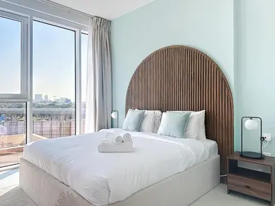 a bedroom with a large bed with a large window at One Residence - Retreat in Dubai