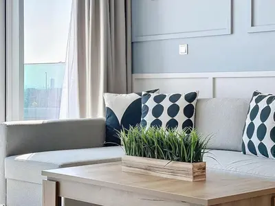 a living room with a couch with pillows and a table at One Residence - Retreat in Dubai