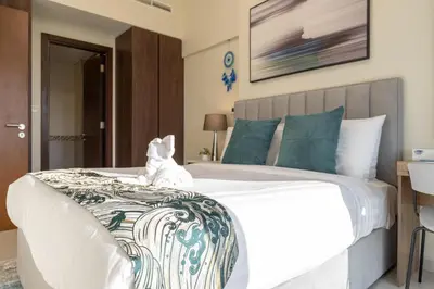 a white teddy bear sitting on top of a bed at Stunning Burj View - Cozy 2BR - 5 min Dubai Mall in Dubai