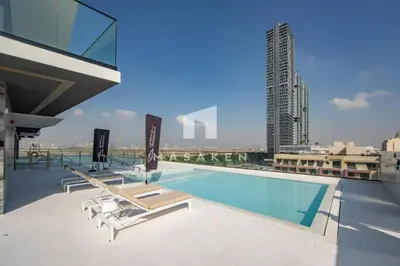a swimming pool on the roof of a building at Chic & Serene 1br Apt Balcony, Pool & Parking in Dubai
