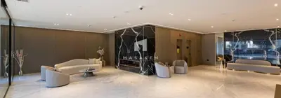a lobby with couches and a fireplace in a building at Chic & Serene 1br Apt Balcony, Pool & Parking in Dubai