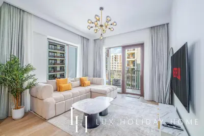 a living room with a couch and a table at LUX The Dubai Creek Beach Suite in Dubai