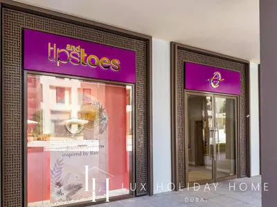 two signs on the side of a store at LUX The Dubai Creek Beach Suite in Dubai