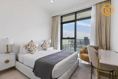 a bedroom with a bed and a large window at Keysplease 2 BR Beach Vista, Emaar Beachfront in Dubai