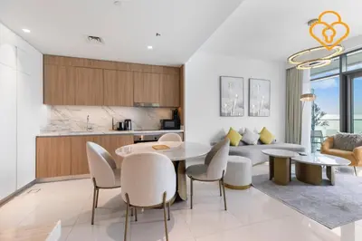 a kitchen and living room with a table and chairs at Keysplease 2 BR Beach Vista, Emaar Beachfront in Dubai