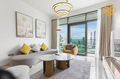 a living room with a couch and a table at Keysplease 2 BR Beach Vista, Emaar Beachfront in Dubai