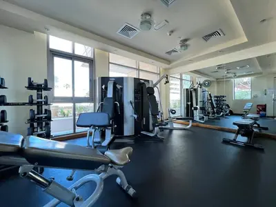a gym with treadmills and machines in a room at Vacay Lettings - Stylish 1 Bedroom Apartment with Marina View, Dubai Marina in Dubai