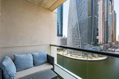 a balcony with blue pillows on a building at Vacay Lettings - Stylish 1 Bedroom Apartment with Marina View, Dubai Marina in Dubai