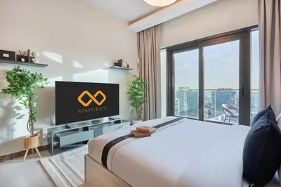a hotel room with a bed and a television at Luxury Studio - SOL BAY Tower - Business Bay by Stayfinity in Dubai