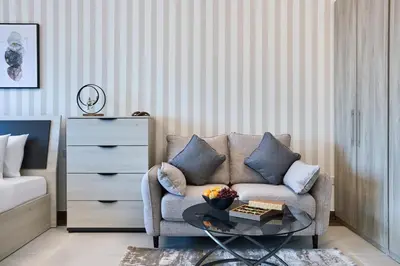 a living room with a couch and a table at Luxury Studio - SOL BAY Tower - Business Bay by Stayfinity in Dubai
