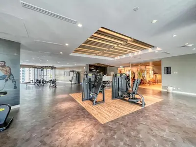 a gym with treadmills and exercise equipment in a building at Stunning Burj View - High Infinity Pool - Cozy 2BR in Dubai