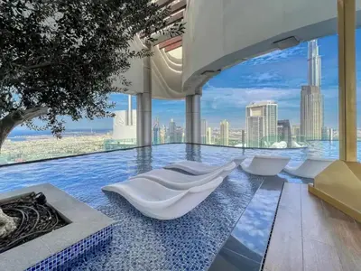 a infinity pool with a view of the city at Stunning Burj View - High Infinity Pool - Cozy 2BR in Dubai