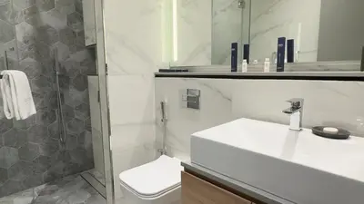a bathroom with a sink and a toilet and a shower at Cozy Studio in Business Bay in Dubai