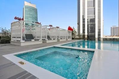 a swimming pool on the roof of a building at Cozy Studio in Business Bay in Dubai