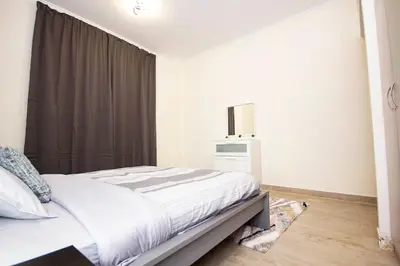 a bedroom with a bed and a window at Newly furnished brand new 1BHK in Al Warsan in Dubai