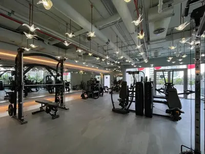 a gym with lots of treadmills and machines at GuestReady - Business Bay delight in Dubai