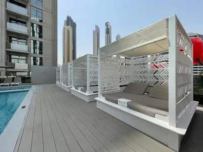 a patio with a bed and a pool on a building at GuestReady - Business Bay delight in Dubai