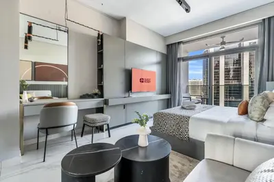 a hotel room with a bed and a desk with a view at GuestReady - Business Bay delight in Dubai