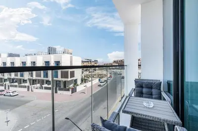 a balcony with a table and a view of a street at Exquisite Brand New Home in the heart of JVC in Dubai