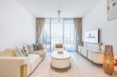 a living room with a couch and a table at Exquisite Brand New Home in the heart of JVC in Dubai