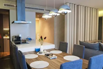 a dining room with a table and blue chairs at Elegant 2BR in Dubai Marina in Dubai