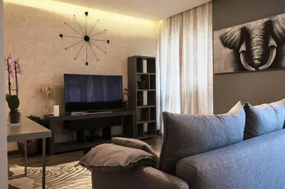 a living room with a couch and a television at Elegant 2BR in Dubai Marina in Dubai