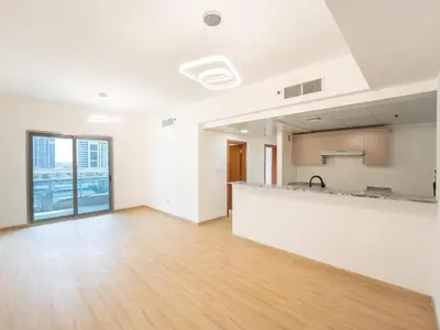 an empty room with a kitchen and a counter at Amiqa Homes Dubai Marina in Dubai