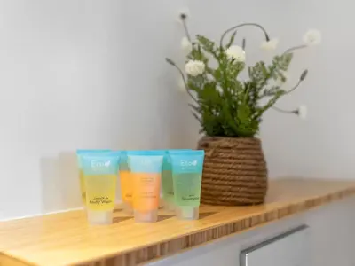 a group of four cups sitting on a wooden shelf at Collective Chic 1BR 15mins to Downtown Dubai Mall Beaches in Dubai