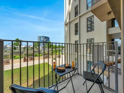 a balcony with chairs and a table with food on it at Collective Chic 1BR 15mins to Downtown Dubai Mall Beaches in Dubai