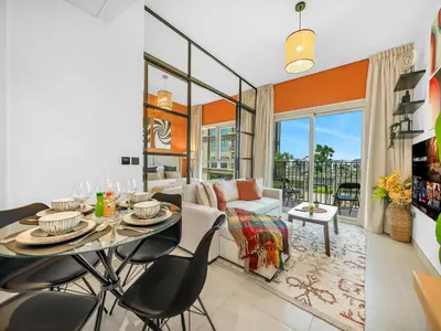 a living room with a table and chairs at Collective Chic 1BR 15mins to Downtown Dubai Mall Beaches in Dubai