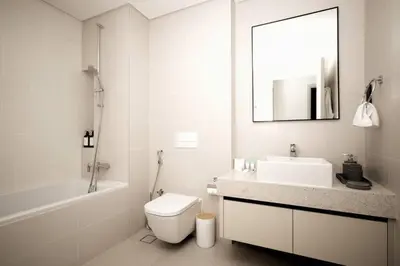 a bathroom with a sink toilet and a mirror at Seafront-side apartment with beach access, pool, gym, high floor in Dubai
