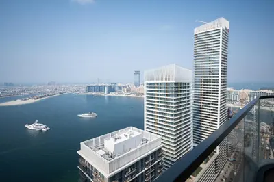 a view of a river with tall buildings and boats at Seafront-side apartment with beach access, pool, gym, high floor in Dubai