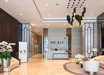 a lobby with a soul bay sign on the wall at Cozy Studio Pool & Gym Near Burj Khalifa & Racecourse views in Dubai