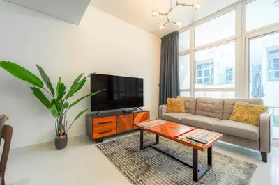 a living room with a couch and a tv at Cozy 2BR Villa in Damac Hills 2 by deleguest in Dubai